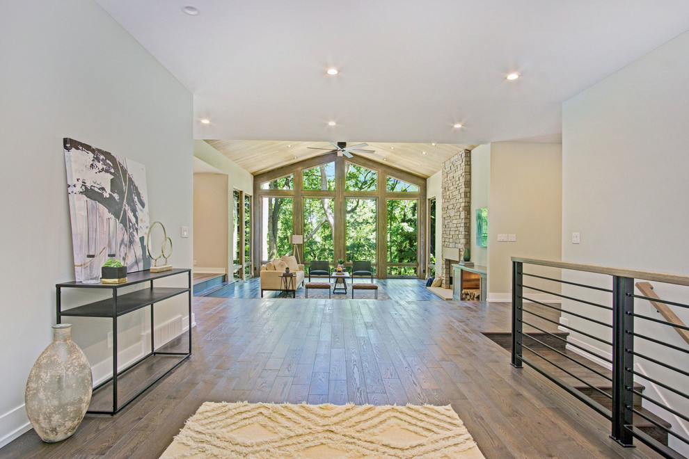 Inspiration for a rustic dark wood floor and brown floor foyer remodel in Grand Rapids with a glass front door