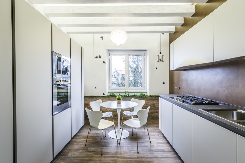 Photo of a contemporary galley kitchen in Rome with a drop-in sink, flat-panel cabinets, white cabinets, brown splashback, stainless steel appliances, dark hardwood floors and no island.