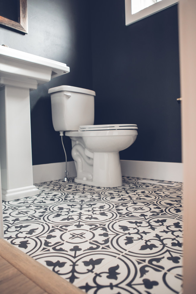 This is an example of a mid-sized transitional powder room in Other with a two-piece toilet, blue walls, cement tiles, a pedestal sink and multi-coloured floor.