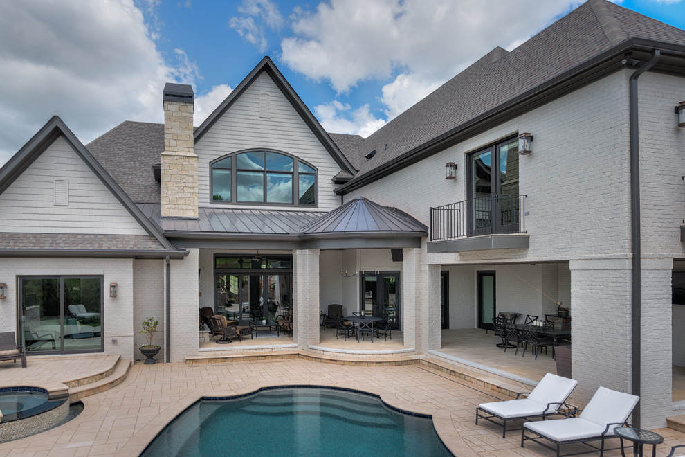 Example of a mid-sized transitional backyard stone patio design