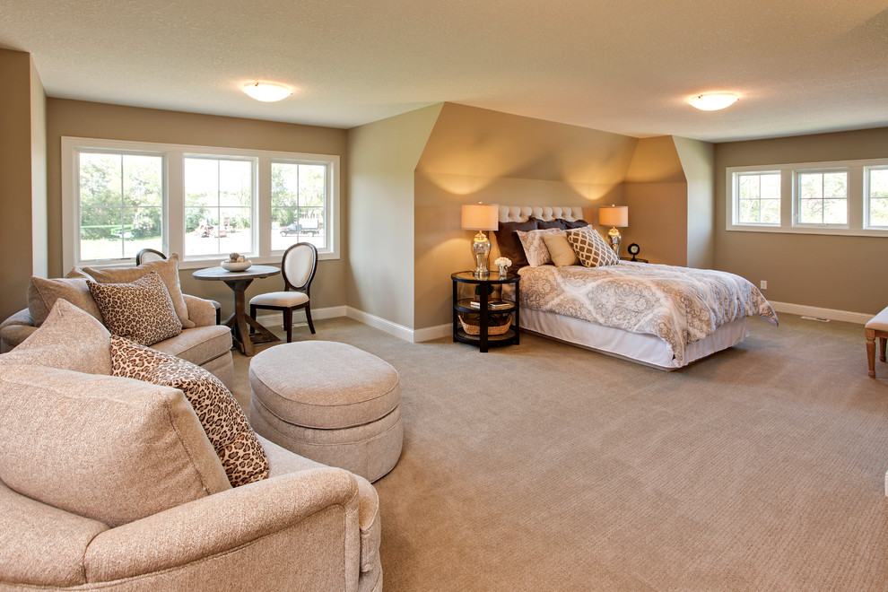 This is an example of a large traditional loft-style bedroom in Minneapolis with beige walls, carpet and no fireplace.