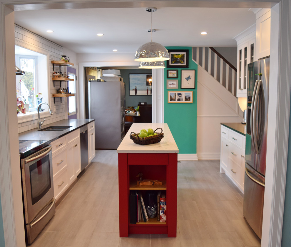 Small eclectic galley light wood floor and beige floor enclosed kitchen photo in Ottawa with an undermount sink, shaker cabinets, white cabinets, quartz countertops, white backsplash, subway tile backsplash, stainless steel appliances, an island and white countertops