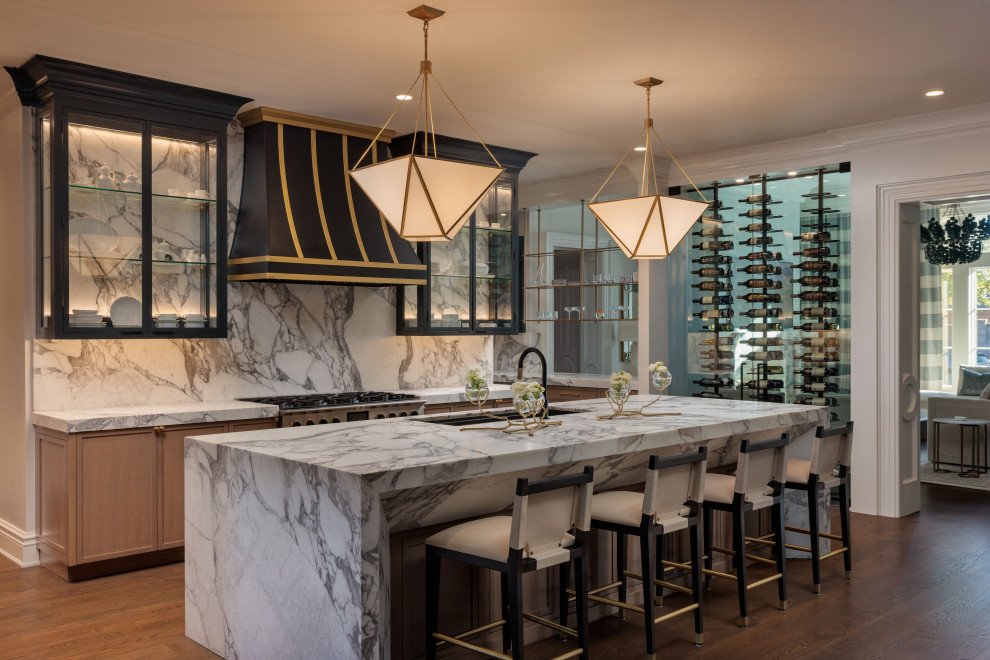 Kitchen - transitional galley dark wood floor and brown floor kitchen idea in Austin with marble countertops, marble backsplash, an undermount sink, shaker cabinets, medium tone wood cabinets, multicolored backsplash, stainless steel appliances, an island and brown countertops