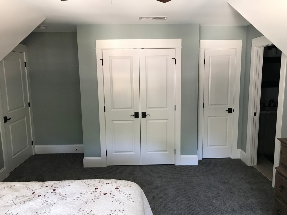 This is an example of a mid-sized arts and crafts guest bedroom in Raleigh with grey walls, carpet, no fireplace and grey floor.