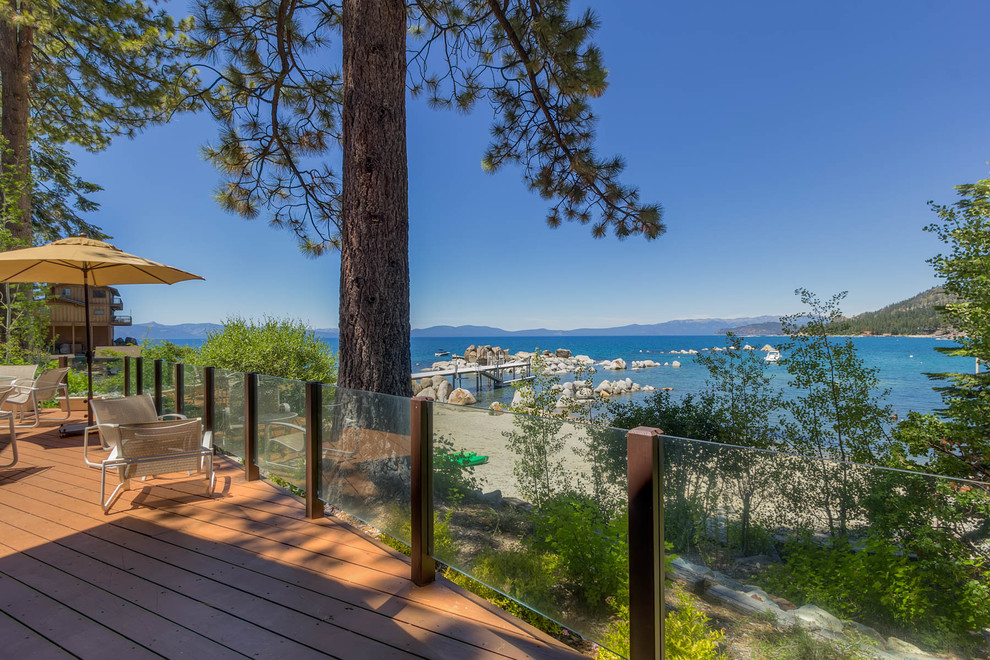 Large mountain style backyard deck photo with no cover