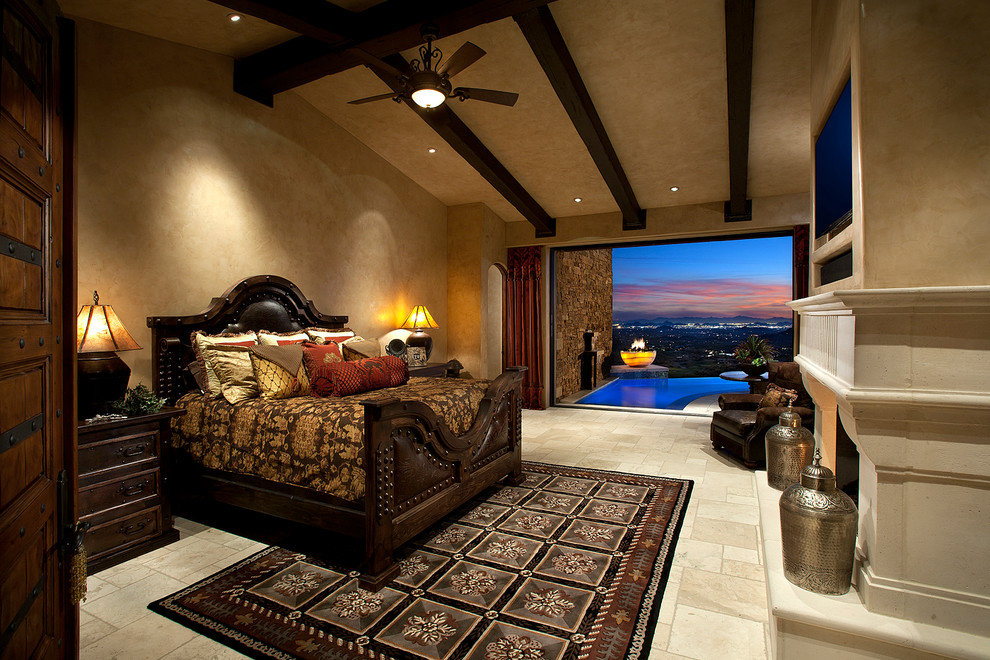Photo of a mediterranean bedroom in Phoenix with beige walls and a standard fireplace.