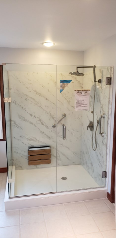 Mid-sized transitional master porcelain tile and gray floor claw-foot bathtub photo with raised-panel cabinets, a two-piece toilet, blue walls, an undermount sink, solid surface countertops, a hinged shower door and multicolored countertops