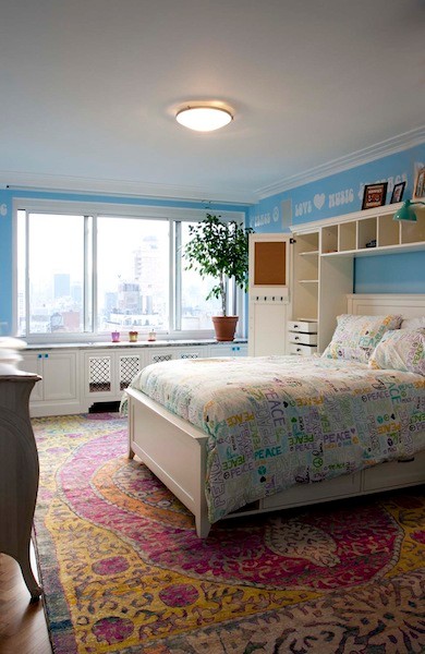 Inspiration for a mid-sized contemporary kids' room for girls in New York with blue walls, medium hardwood floors and brown floor.