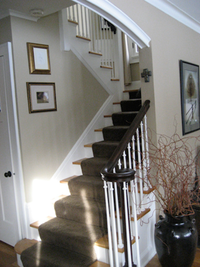 Staircase - carpeted u-shaped staircase idea in Milwaukee with carpeted risers