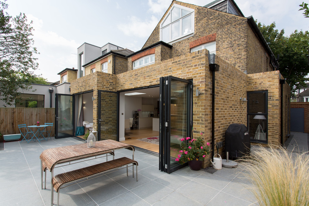 Inspiration for a medium sized and beige contemporary bungalow brick and rear extension in London.