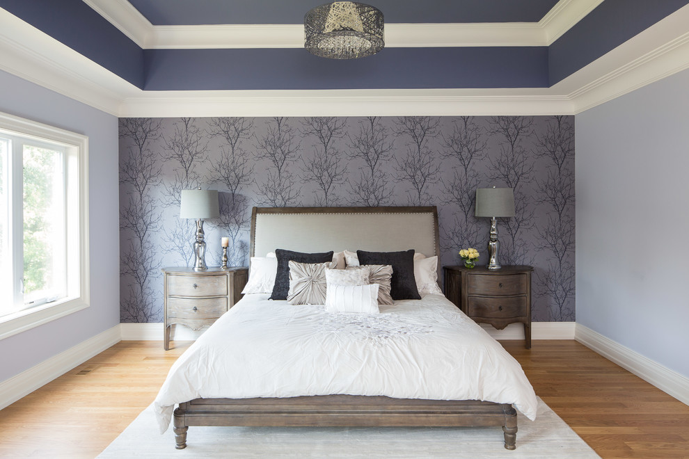 This is an example of a large traditional master bedroom in Toronto with light hardwood floors.