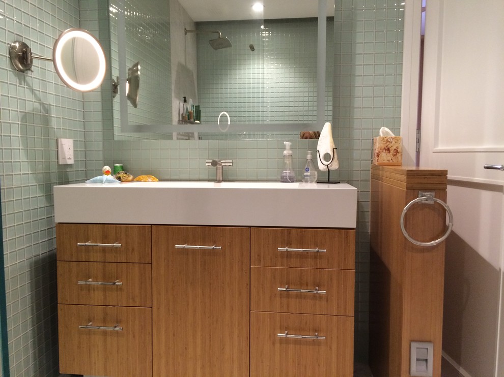 Mid-sized asian master bathroom in San Francisco with flat-panel cabinets, medium wood cabinets, an open shower, a one-piece toilet, green tile, glass tile, green walls, marble floors and a console sink.