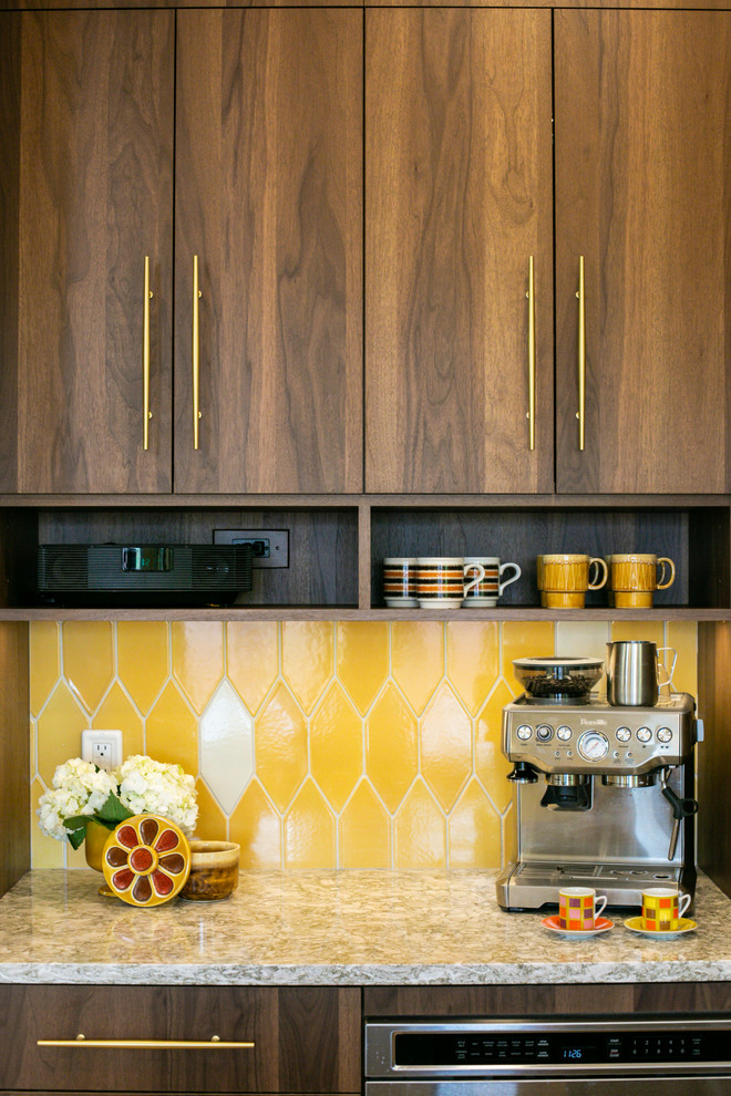Photo of a mid-sized midcentury l-shaped eat-in kitchen in Denver with an undermount sink, flat-panel cabinets, medium wood cabinets, quartz benchtops, yellow splashback, ceramic splashback, stainless steel appliances, light hardwood floors, with island, brown floor and multi-coloured benchtop.
