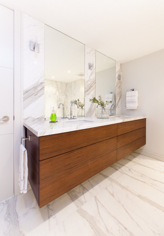 Photo of a large contemporary master bathroom in Toronto with flat-panel cabinets, medium wood cabinets, white tile, marble, white walls, marble floors, a drop-in sink, marble benchtops, white floor, a corner shower, a hinged shower door and a drop-in tub.