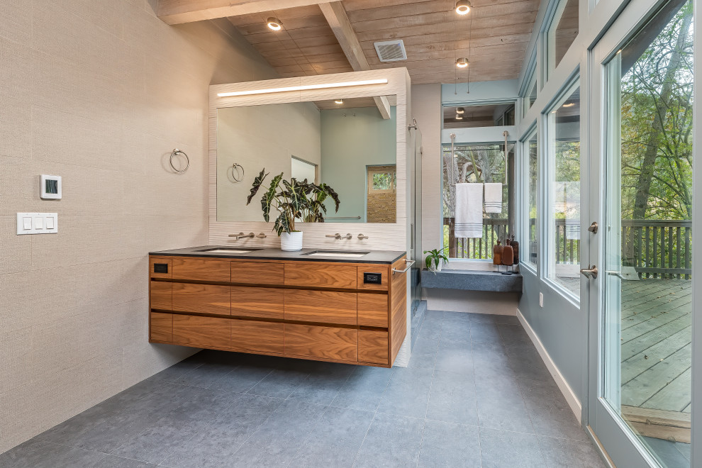 Mid-sized contemporary master bathroom in Los Angeles with flat-panel cabinets, an open shower, beige tile, porcelain tile, blue walls, porcelain floors, an undermount sink, engineered quartz benchtops, grey floor, a hinged shower door, grey benchtops, a shower seat, a double vanity, a floating vanity and exposed beam.