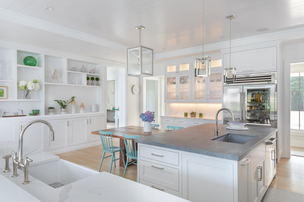 Inspiration for a mid-sized transitional l-shaped light wood floor, beige floor and shiplap ceiling eat-in kitchen remodel with a farmhouse sink, recessed-panel cabinets, white cabinets, quartz countertops, white backsplash, stone slab backsplash, stainless steel appliances, an island and white countertops