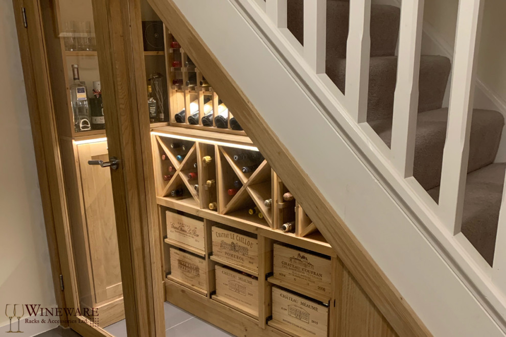 Mid-sized contemporary wine cellar in Oxfordshire with grey floor.