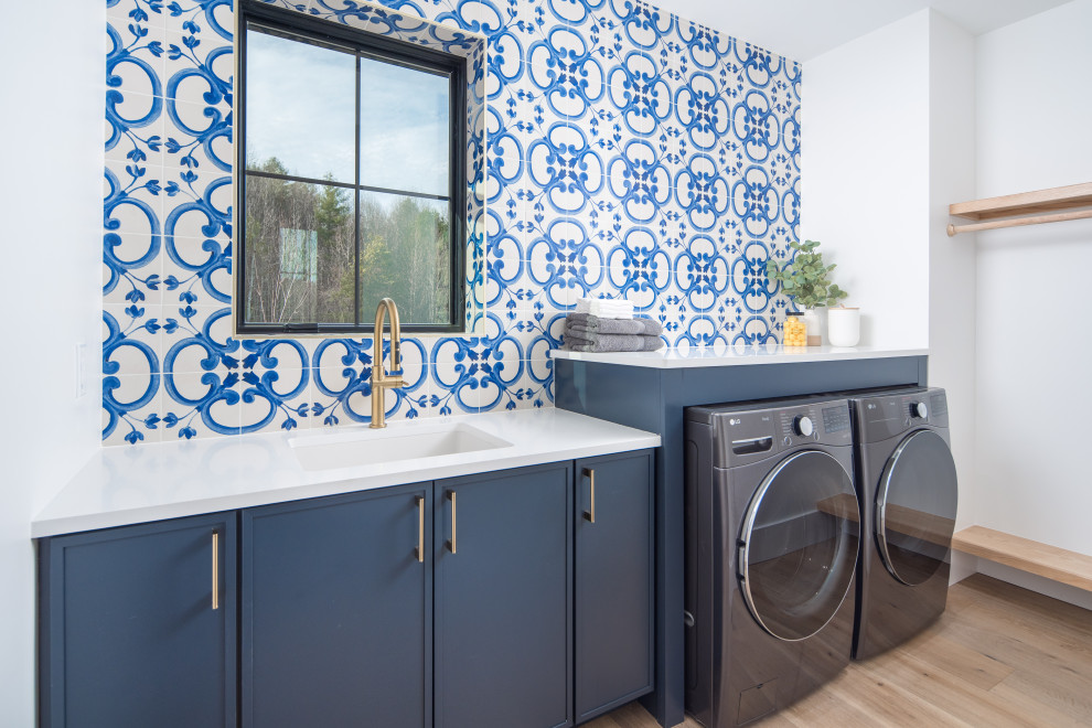 Transitional laundry room photo with ceramic backsplash