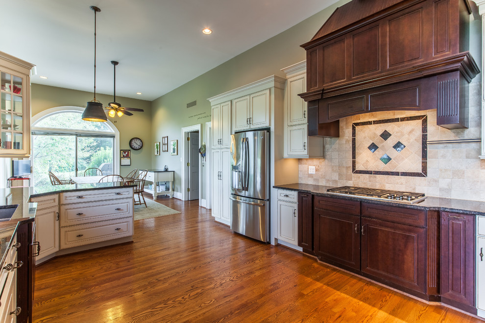 Example of a huge transitional medium tone wood floor eat-in kitchen design in DC Metro with raised-panel cabinets, granite countertops, stainless steel appliances and an island