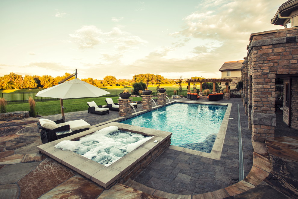 Inspiration for a mid-sized country backyard rectangular pool in Denver with concrete pavers.