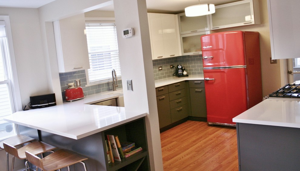 Mid-sized minimalist u-shaped medium tone wood floor kitchen photo with a farmhouse sink, flat-panel cabinets, gray cabinets, quartz countertops, blue backsplash, subway tile backsplash and colored appliances