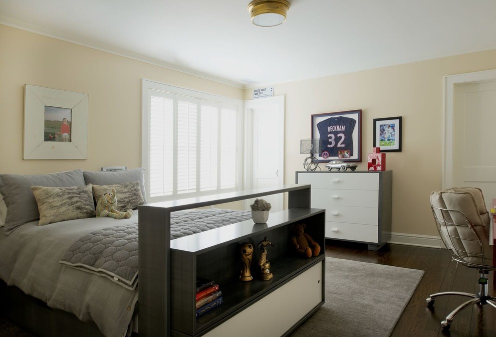 Photo of a mid-sized transitional kids' room for boys in DC Metro with dark hardwood floors, beige walls and brown floor.