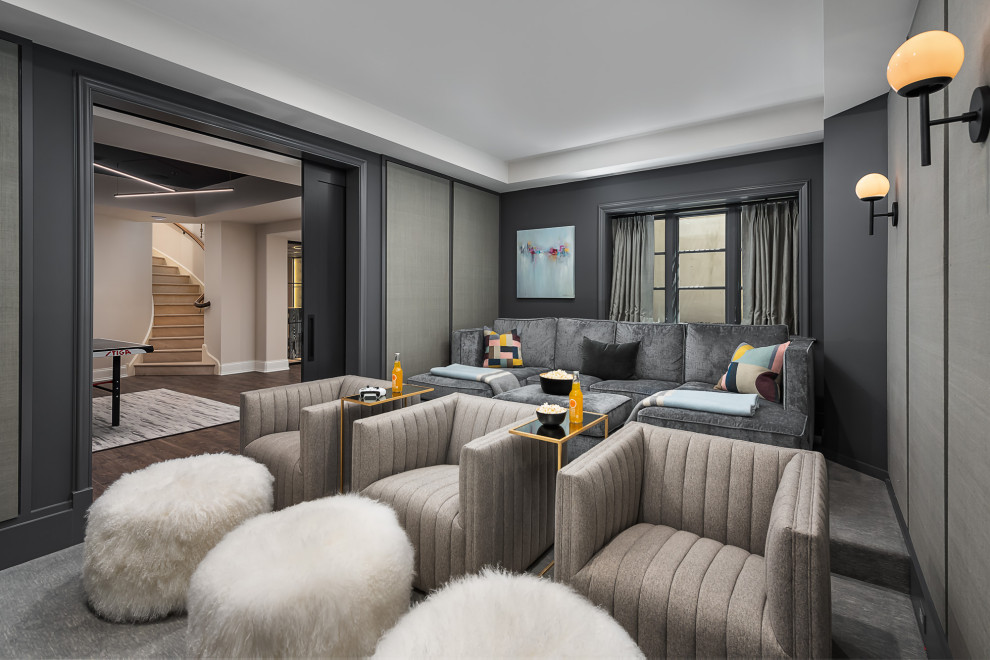 This is an example of a large transitional enclosed home theatre in Chicago with grey walls, carpet and grey floor.
