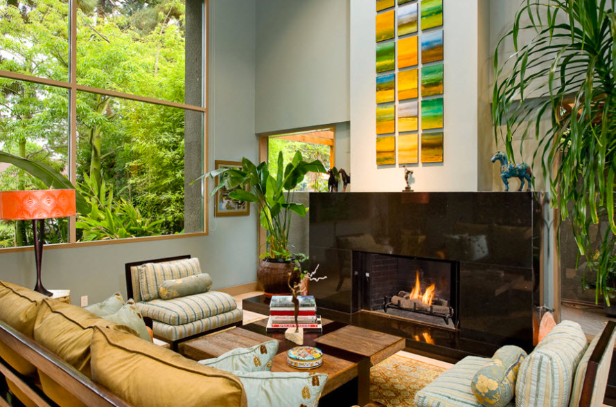Photo of a mid-sized eclectic enclosed living room in Los Angeles with green walls, carpet, a standard fireplace, a stone fireplace surround and no tv.