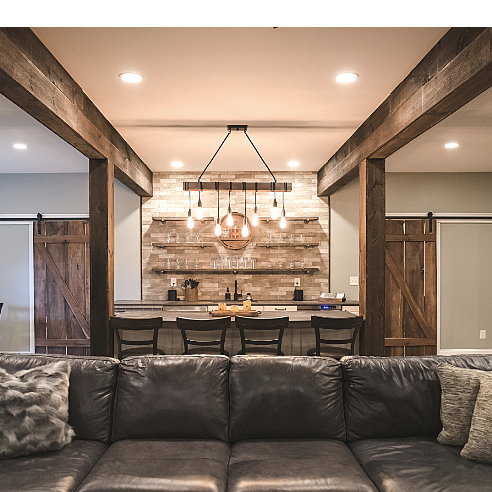 Large country walk-out basement in Other with grey walls, vinyl floors, a standard fireplace, a brick fireplace surround, brown floor, exposed beam and wood walls.