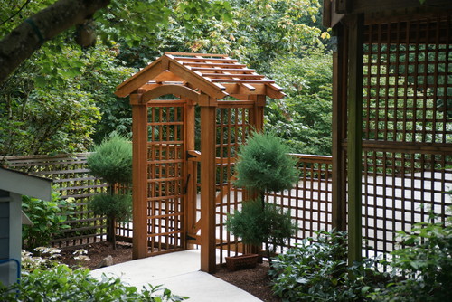 This is a simple and clean lattice fence with an arched gate.