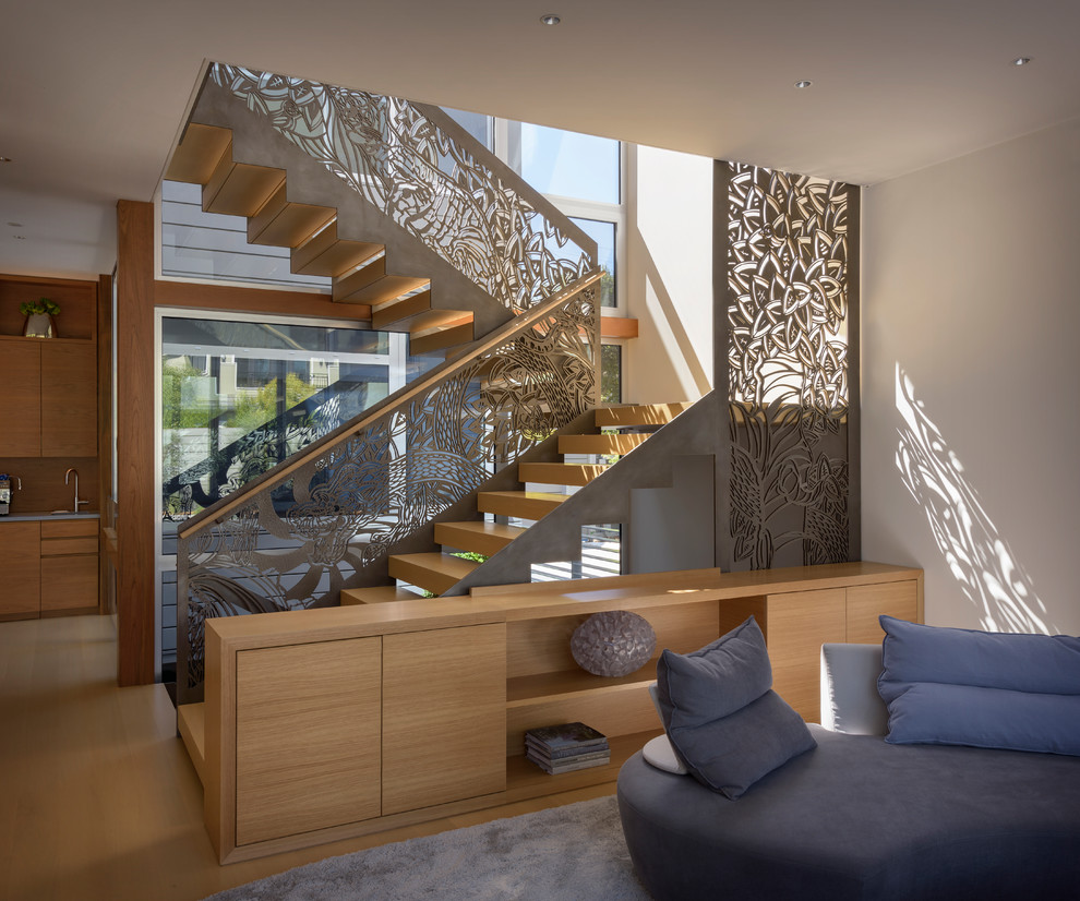 Inspiration for a contemporary wood u-shaped staircase in San Francisco with metal railing.