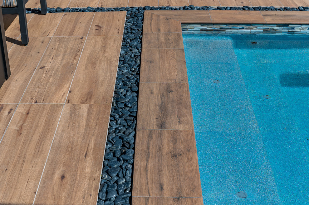 Small backyard tile and rectangular pool photo in Phoenix