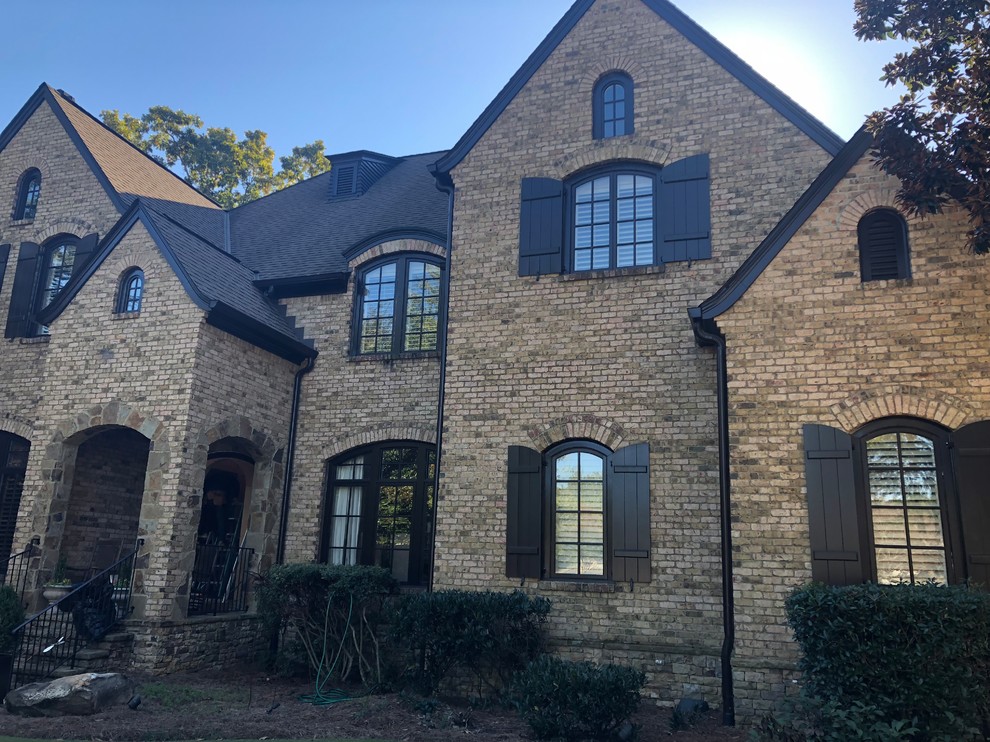 Inspiration for a large transitional three-storey brick white house exterior in Atlanta with a gable roof and a shingle roof.