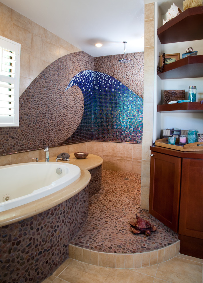 Inspiration for a large beach style master bathroom in San Diego with mosaic tile, recessed-panel cabinets, dark wood cabinets, a drop-in tub, an open shower, blue tile, multi-coloured walls, pebble tile floors, solid surface benchtops, grey floor and an open shower.