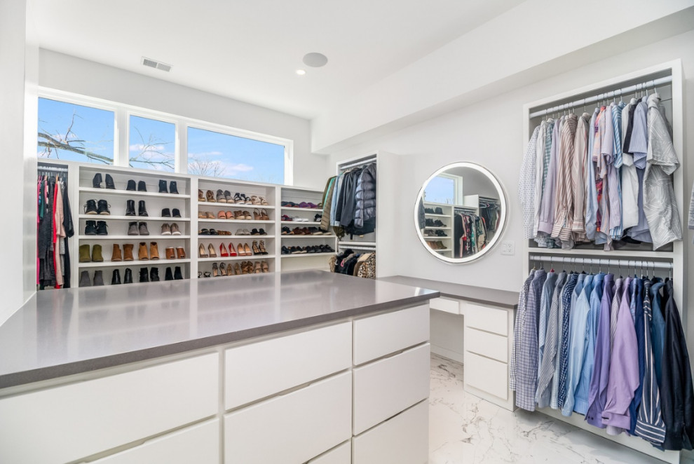 Design ideas for a large contemporary gender-neutral storage and wardrobe in Chicago with flat-panel cabinets, white cabinets, marble floors and grey floor.