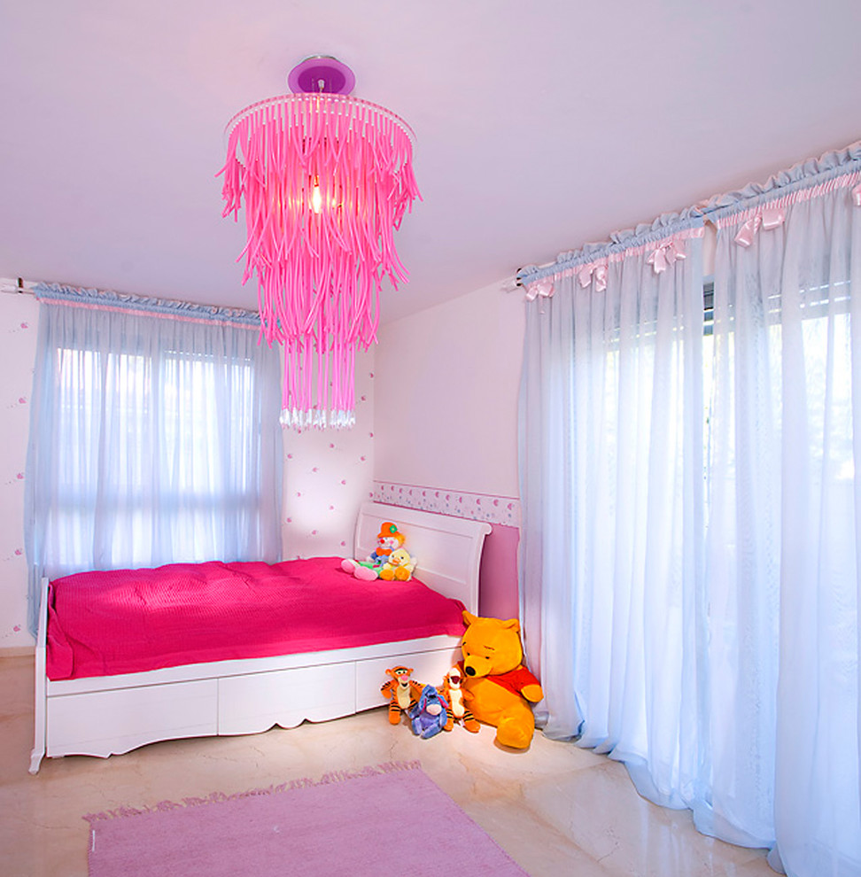 This is an example of a contemporary kids' room for girls in Other with white walls.