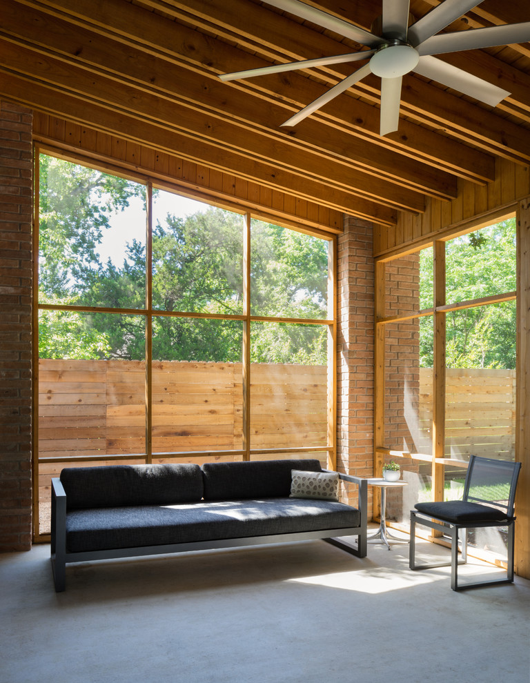 Design ideas for a contemporary two-storey exterior in Austin with wood siding.