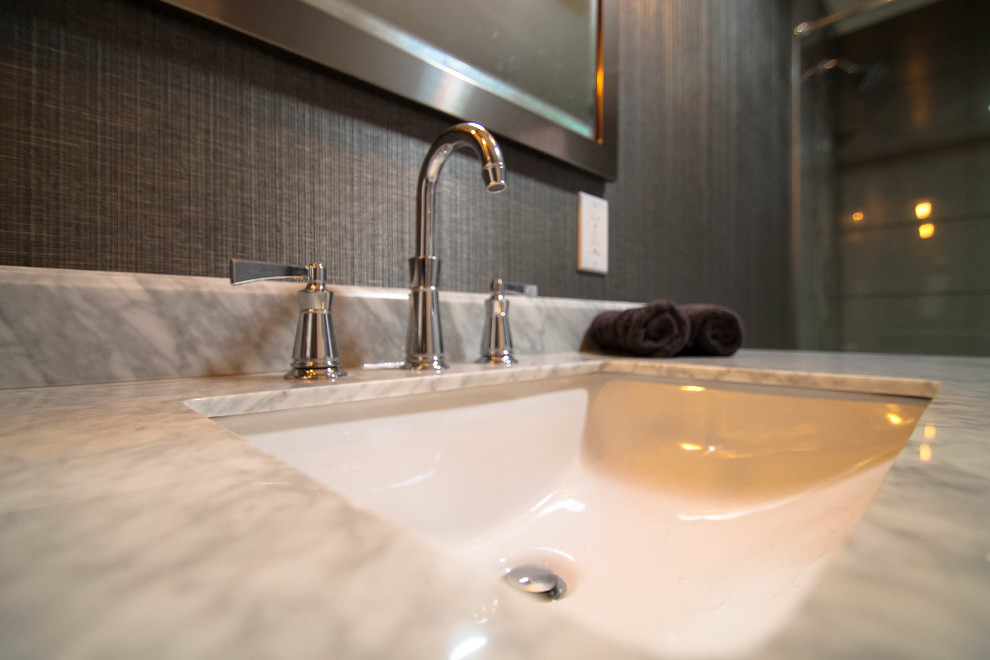 Example of a mid-sized transitional gray tile and glass tile porcelain tile home design design in Denver with shaker cabinets, gray cabinets, a one-piece toilet, gray walls, an undermount sink and marble countertops