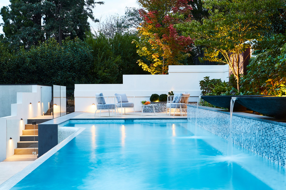 Design ideas for a midcentury backyard custom-shaped pool in Melbourne.