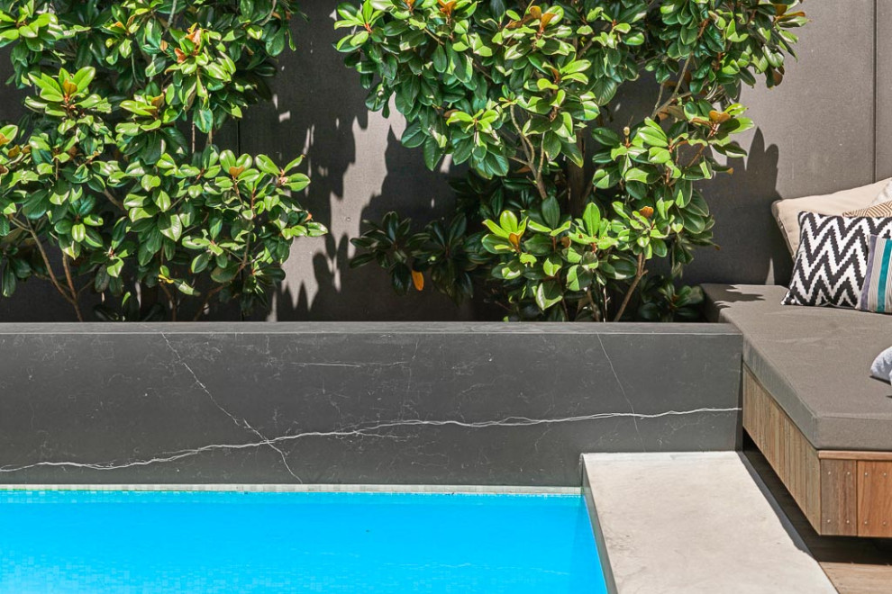 Large contemporary back private and rectangular swimming pool in Sydney with with pool landscaping and concrete paving.
