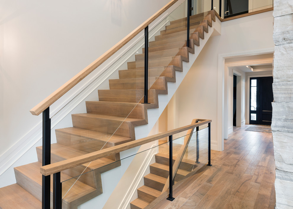 Design ideas for a large contemporary wood straight staircase in Toronto with wood risers.