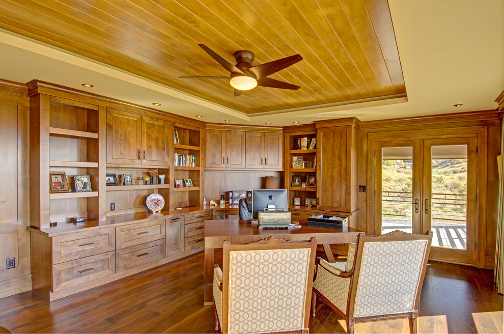 Photo of a large country study room in Denver with dark hardwood floors, no fireplace and a freestanding desk.