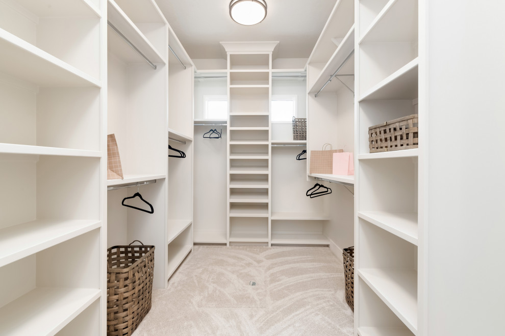 Inspiration for a large country gender-neutral walk-in wardrobe in Boise with open cabinets, white cabinets, carpet and grey floor.