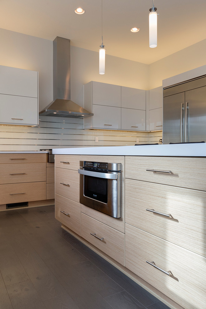 This is an example of a large modern u-shaped eat-in kitchen in Other with an undermount sink, open cabinets, white cabinets, quartzite benchtops, white splashback, glass tile splashback, stainless steel appliances, dark hardwood floors and with island.