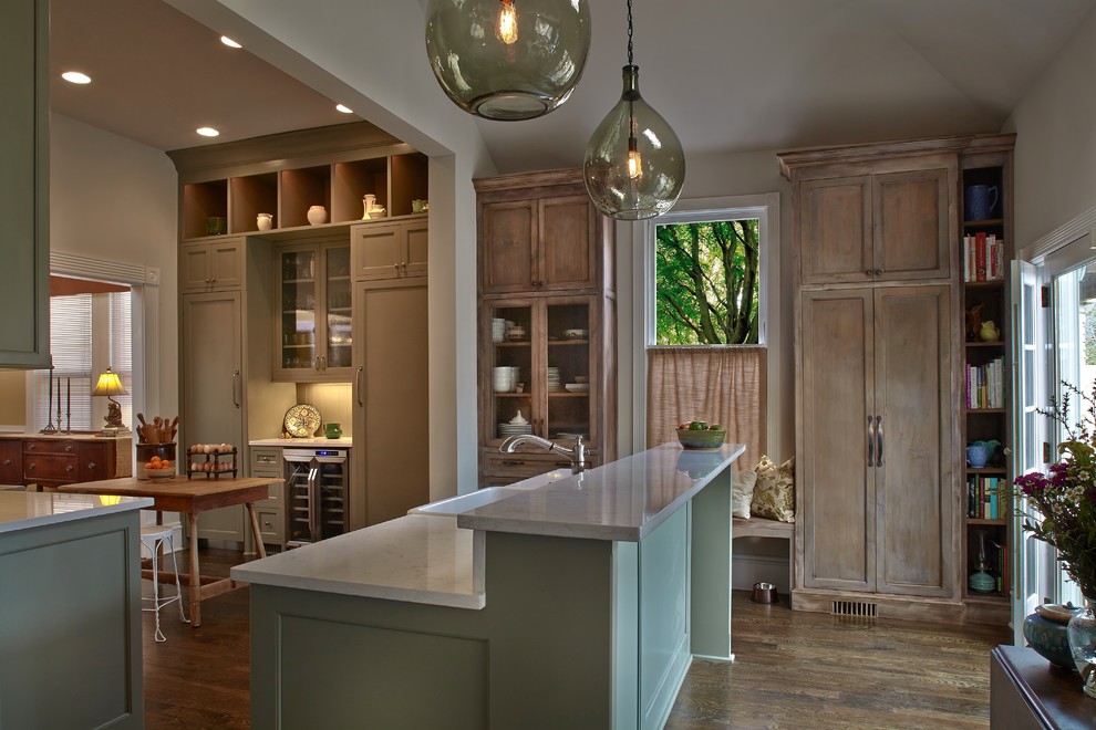 Photo of a mid-sized country u-shaped open plan kitchen in Atlanta with a farmhouse sink, shaker cabinets, green cabinets, brown splashback, ceramic splashback, panelled appliances, medium hardwood floors, with island and brown floor.