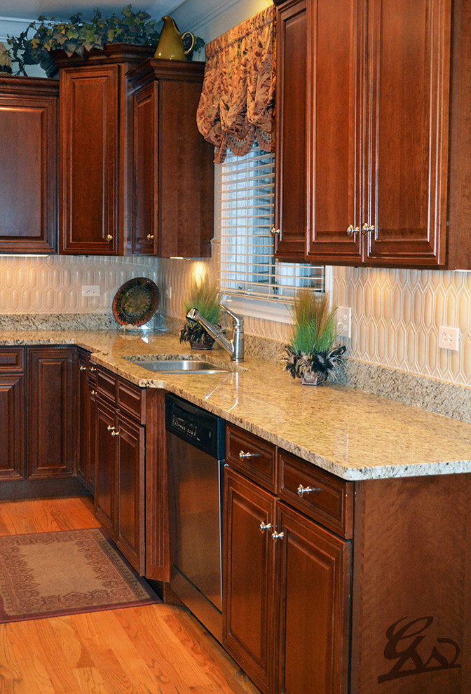 Kitchen - mediterranean medium tone wood floor and brown floor kitchen idea in Chicago with ceramic backsplash, granite countertops and beige backsplash