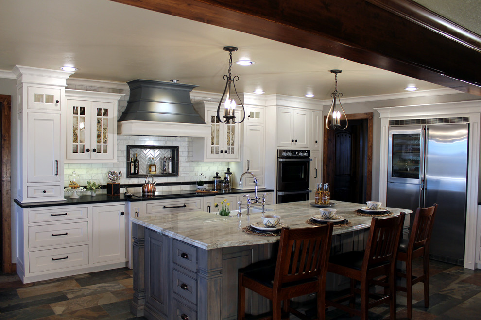 Design ideas for a large transitional eat-in kitchen in Oklahoma City with beaded inset cabinets, white cabinets, soapstone benchtops, white splashback, stone tile splashback and porcelain floors.