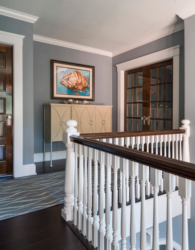 Design ideas for a mid-sized beach style hallway in Providence with grey walls and dark hardwood floors.