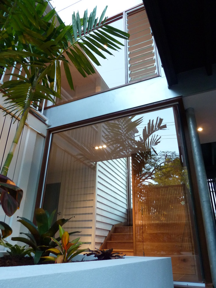 Design ideas for a mid-sized contemporary exterior in Brisbane with a flat roof.