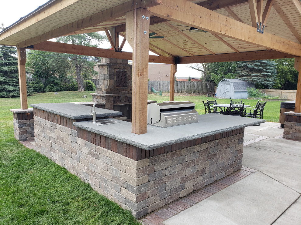 Inspiration for a medium sized classic back patio in Milwaukee with an outdoor kitchen, concrete slabs and a pergola.